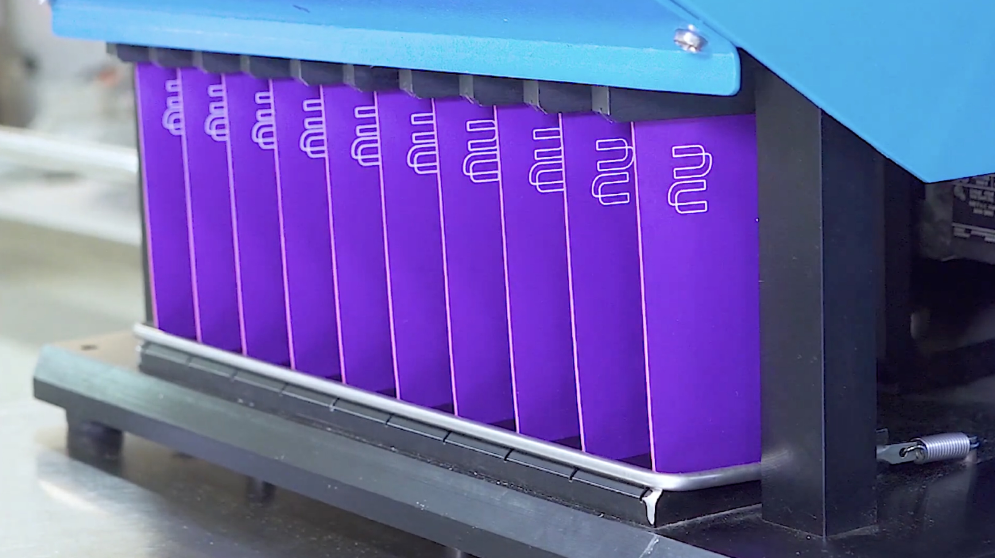 Purple Nubank cards on the factory line